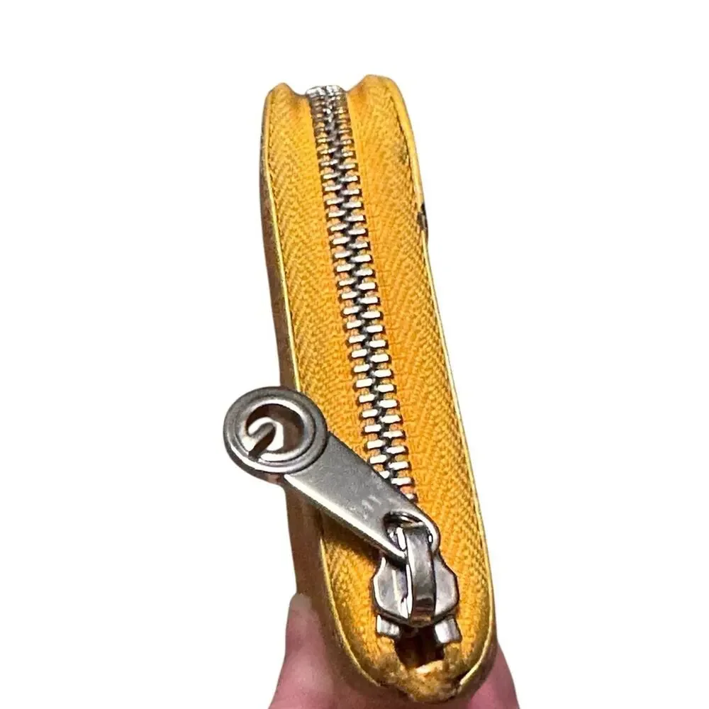 Goyard Matignon zip-around wallet in yellow orange Goyardine canvas.